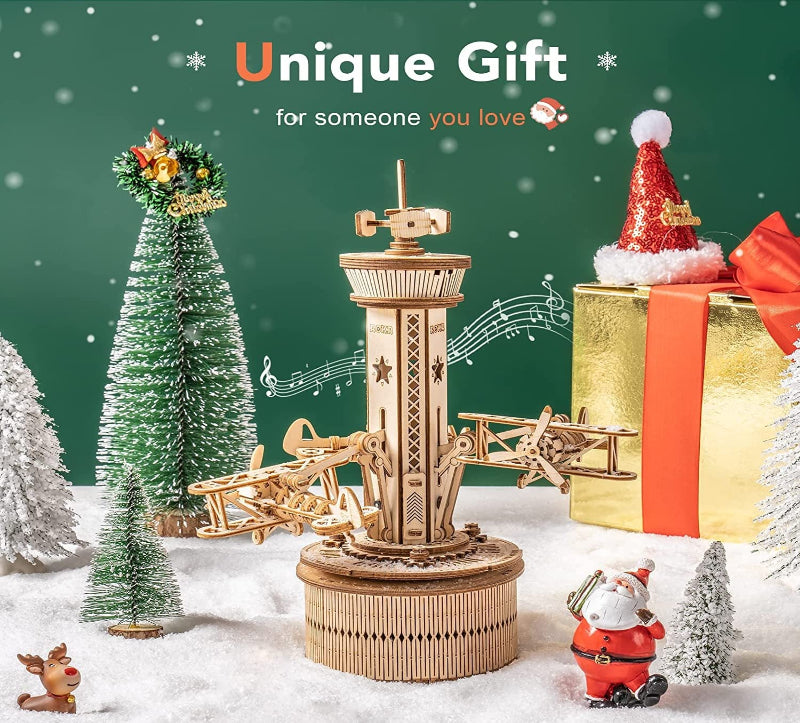 Wooden mechanical model with Christmas decorations on a snowy background