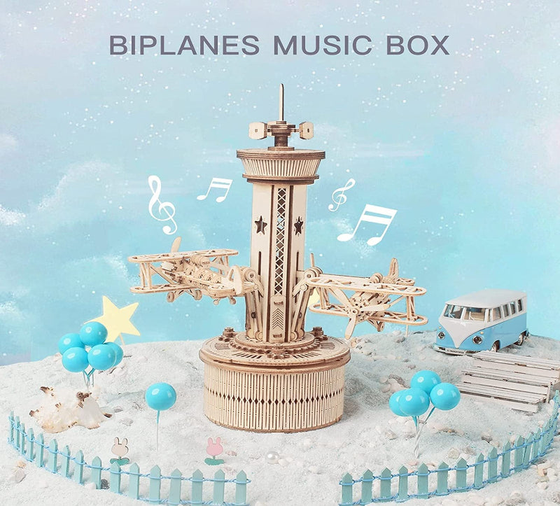 Wooden biplanes music box with decorative elements on a snowy background