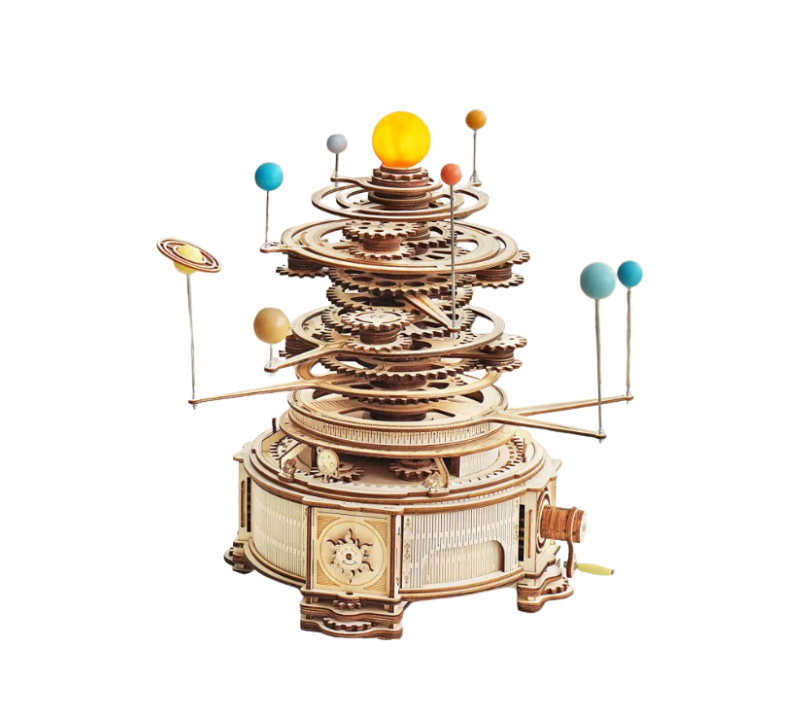 Wooden mechanical model of a solar system on a white background