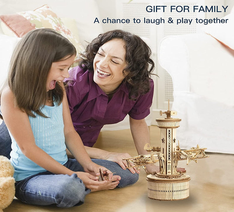 Woman and child playing with a wooden toy together, with text 'Gift for Family' and 'A chance to laugh & play together'.