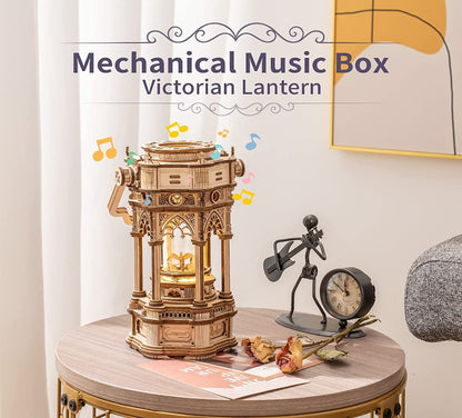 Mechanical music box labeled 'Victorian Lantern' on a table with decorative items.