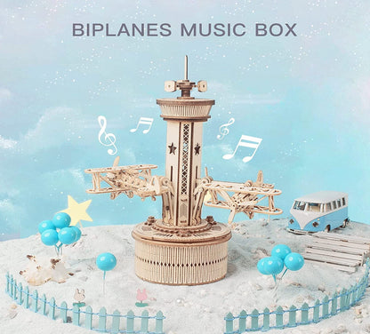 Wooden biplanes music box with decorative elements on a snowy background