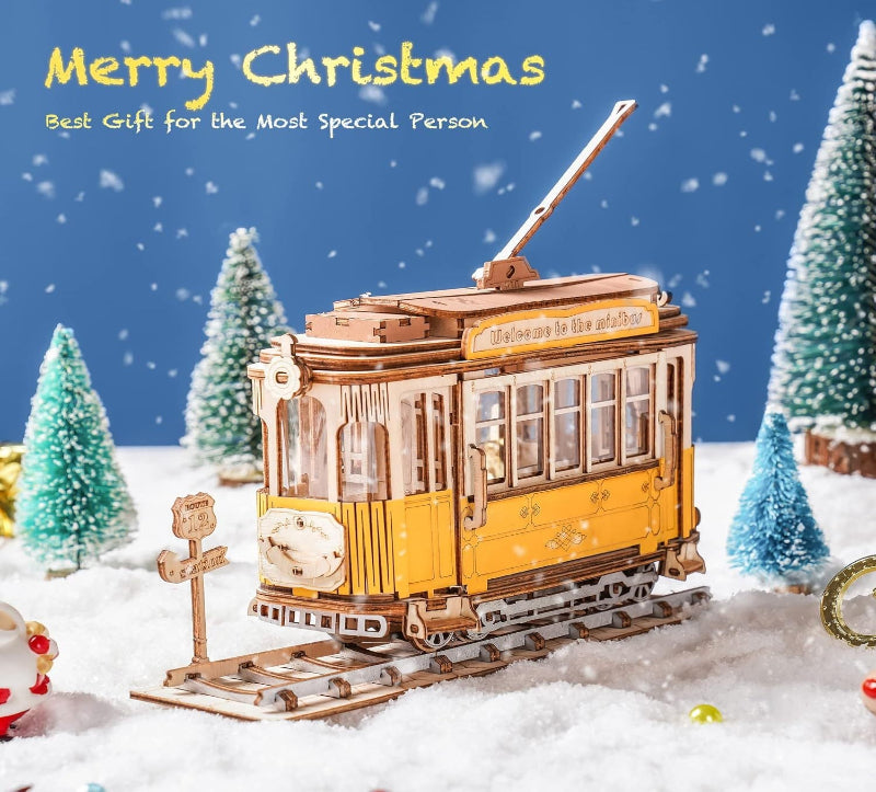 Model tram in a snowy landscape with Christmas trees and text 'Merry Christmas, Best Gift for the Most Special Person'.