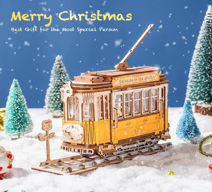 Model tram in a snowy landscape with Christmas trees and text 'Merry Christmas, Best Gift for the Most Special Person'.